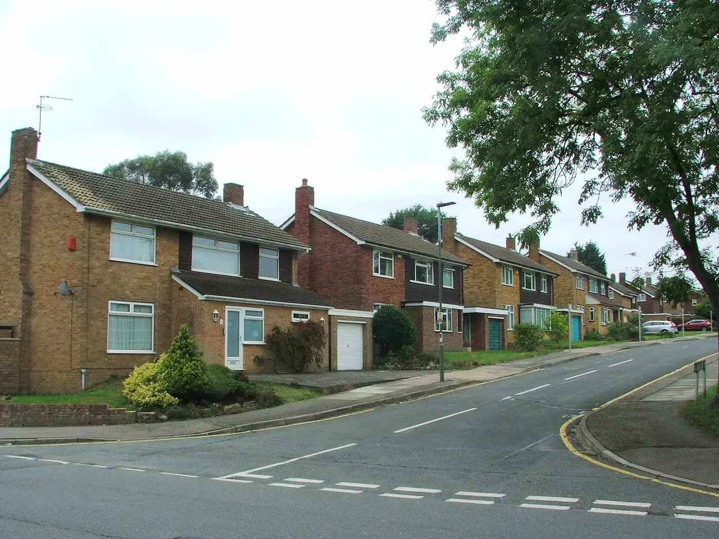 Brick semi-detached houses with front gardens on Cheriton Avenue, Bromley