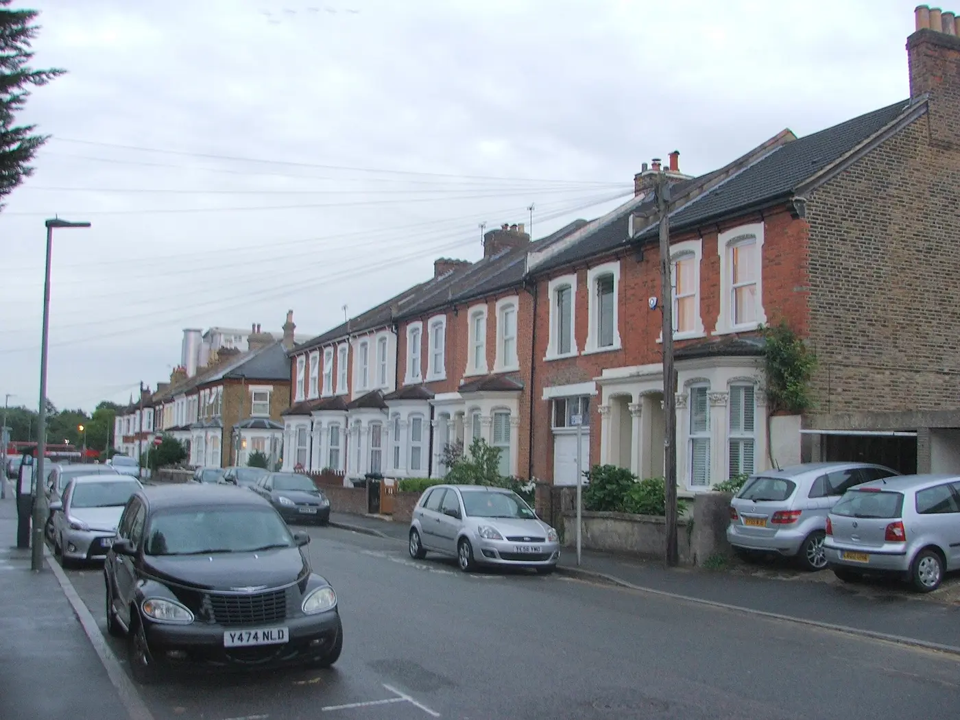 Row of Victorian red-brick terraced houses with bay windows on Glebe Road, Bromley