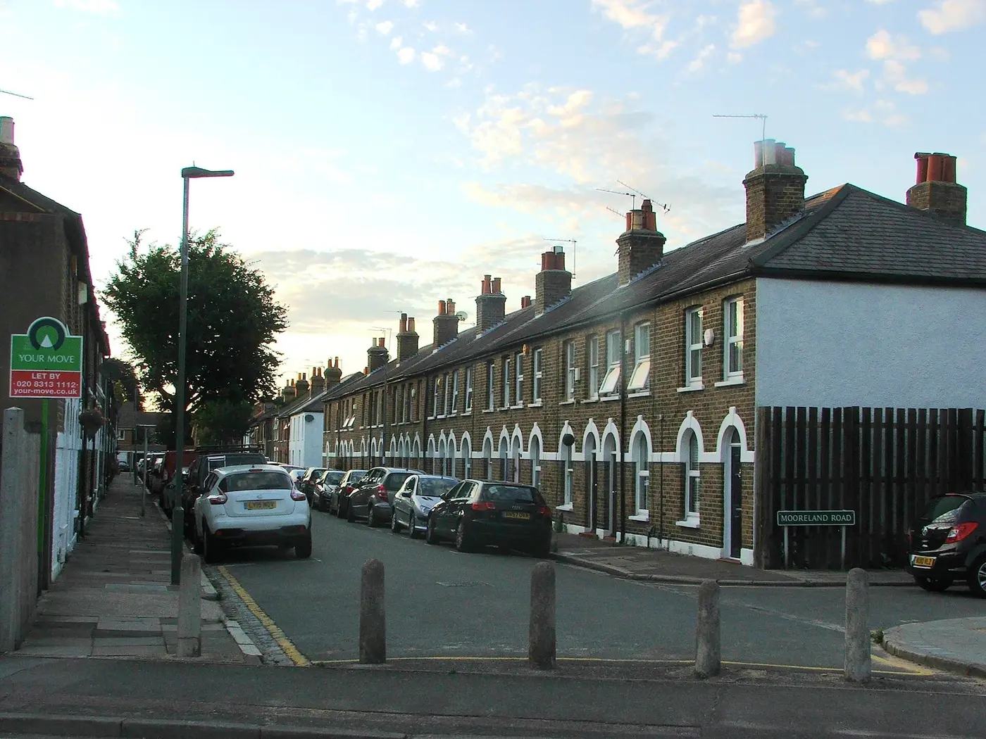 Terrace of small two-storey cottages with pitched roofs and chimneys on Mooreland Road, Bromley