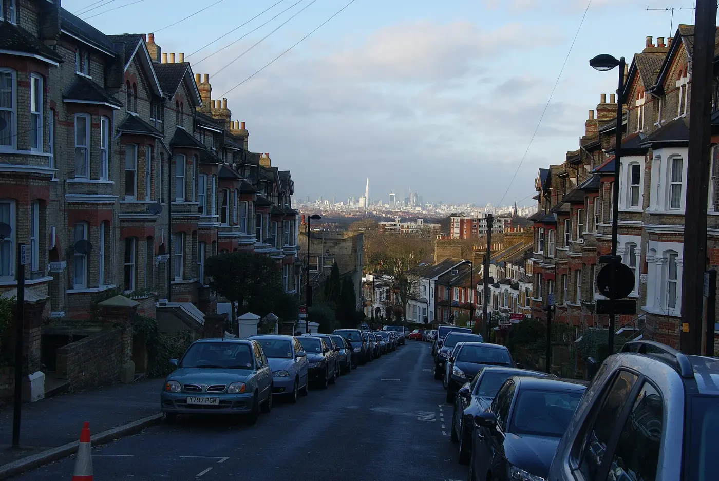 Steep street of tall Victorian houses with gables and bay windows on Woodland Road, Crystal Palace