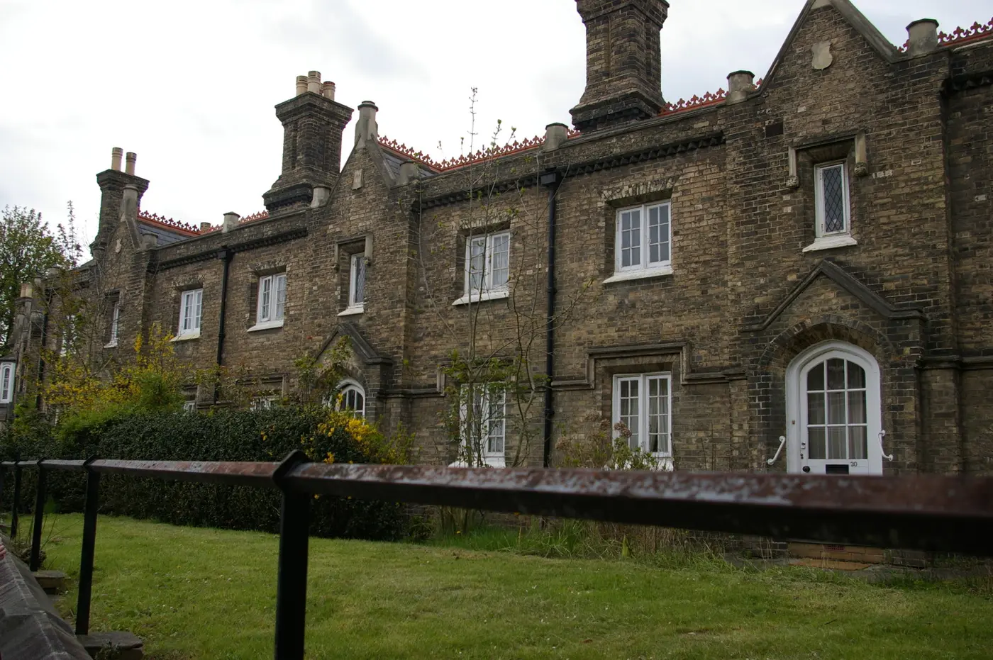 Victorian Gothic-style almshouses in yellow brick with tall chimneys, Penge
